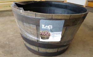 Empty resin whiskey barrel to use as flower planter